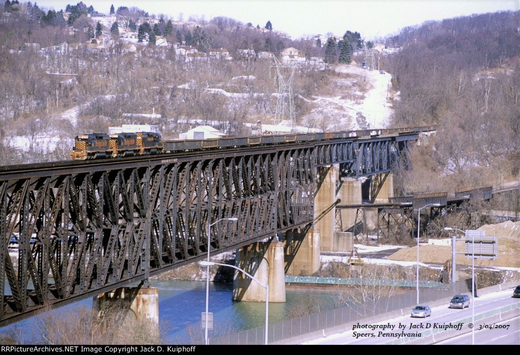 W&LE, Wheeling and Lake Erie SD40s 3048- 3016- 3046, leads a westbound slab train across the Monongahela River at Speers, Pennsylvania. March 4, 2007. 
